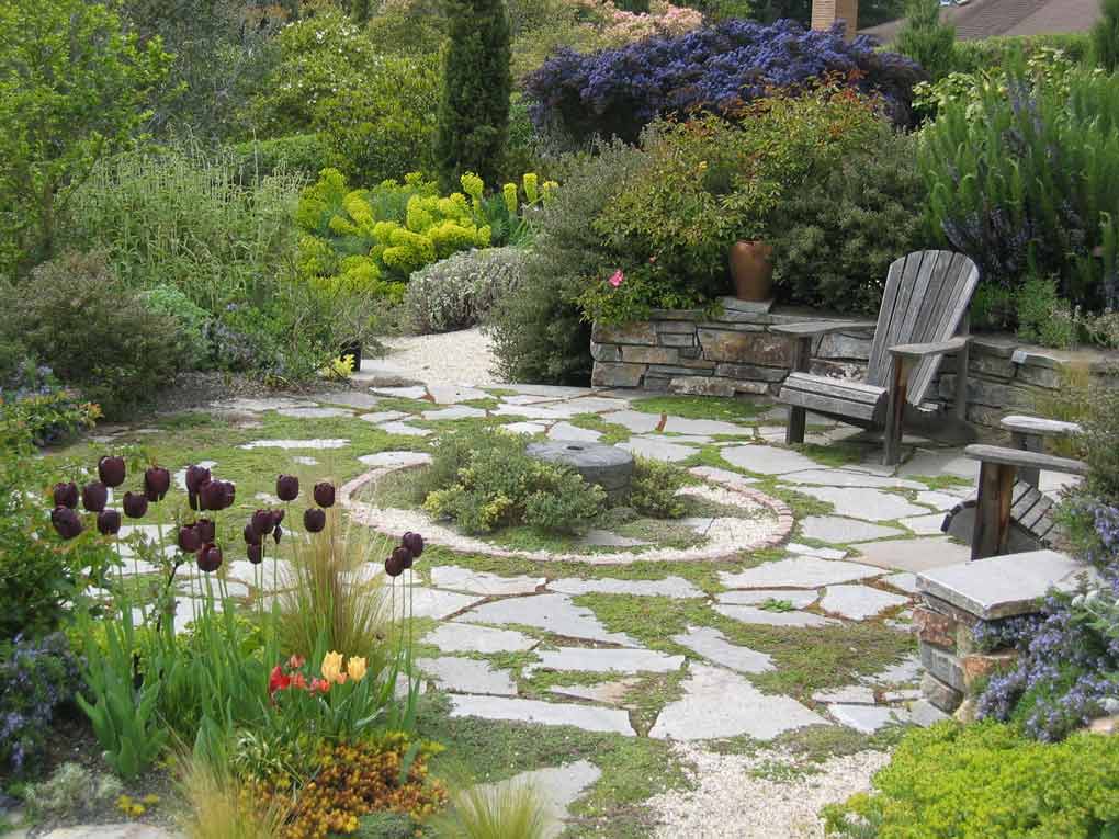 Patio-with-stone-paving-gives-a-focal-point-a-Mediterranean-garden-in-Seatle.jpg