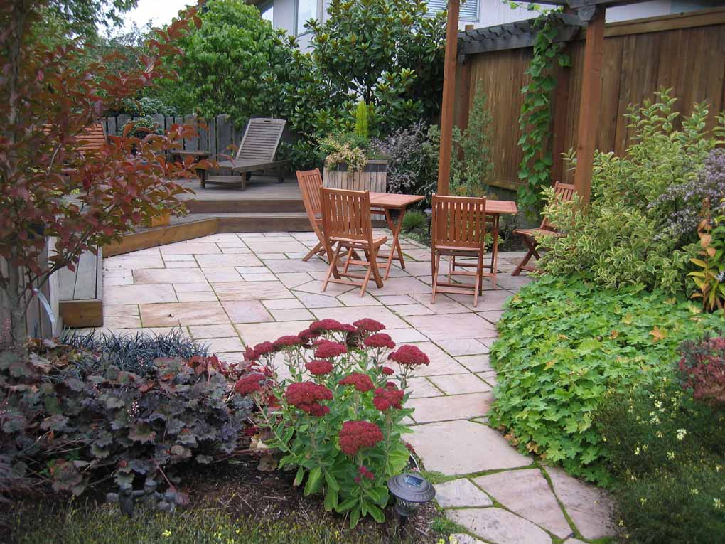 Stone paved patio and lush planings give year round interest