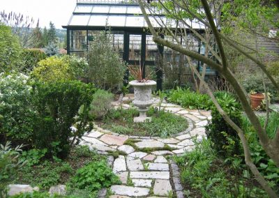 The english greenhouse presides over the circular path