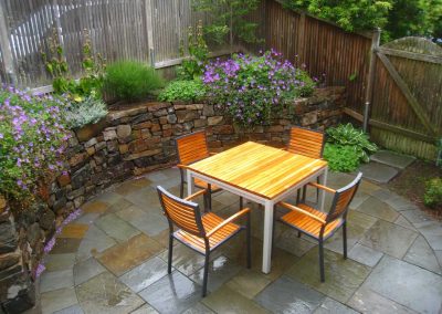 This stone wall provides a level area for outdoor dining